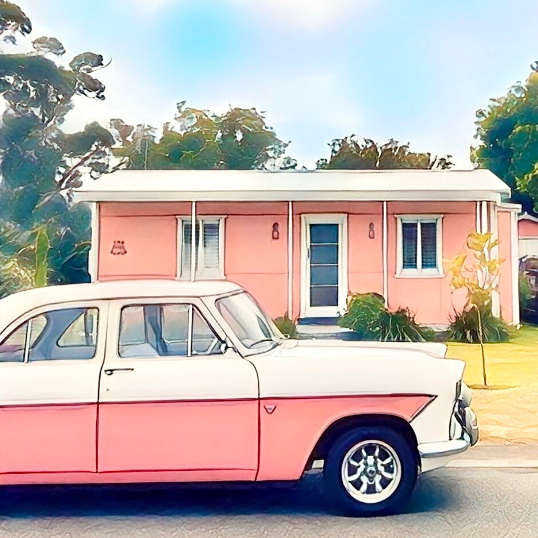 A pink Zeyher parked in front of a classic pink fibro beach shack fridge magnet
