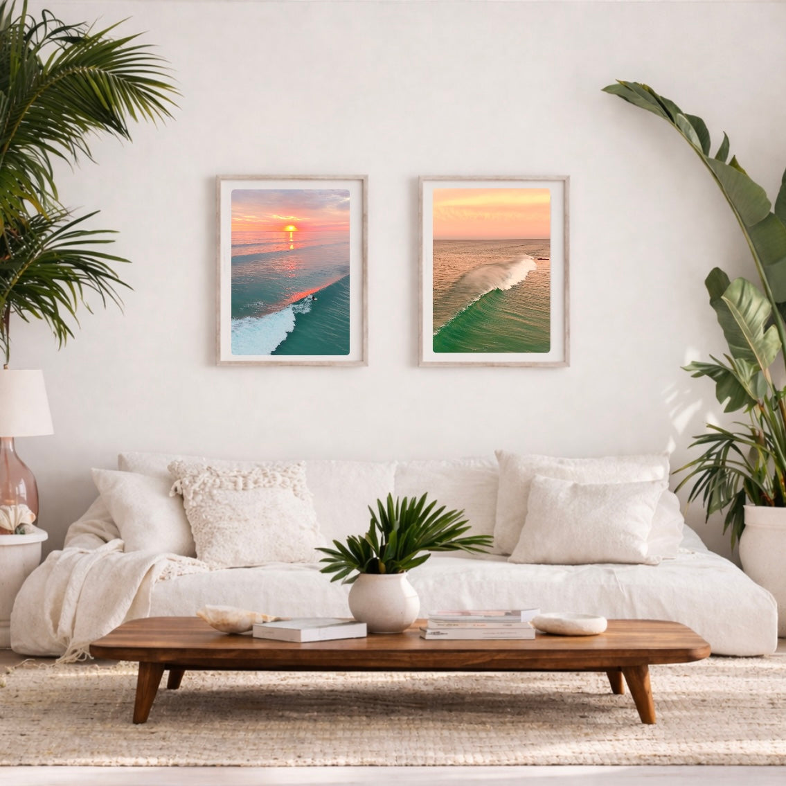 Living room with white sofa, wooden coffee table, and framed beach photos on the wall.