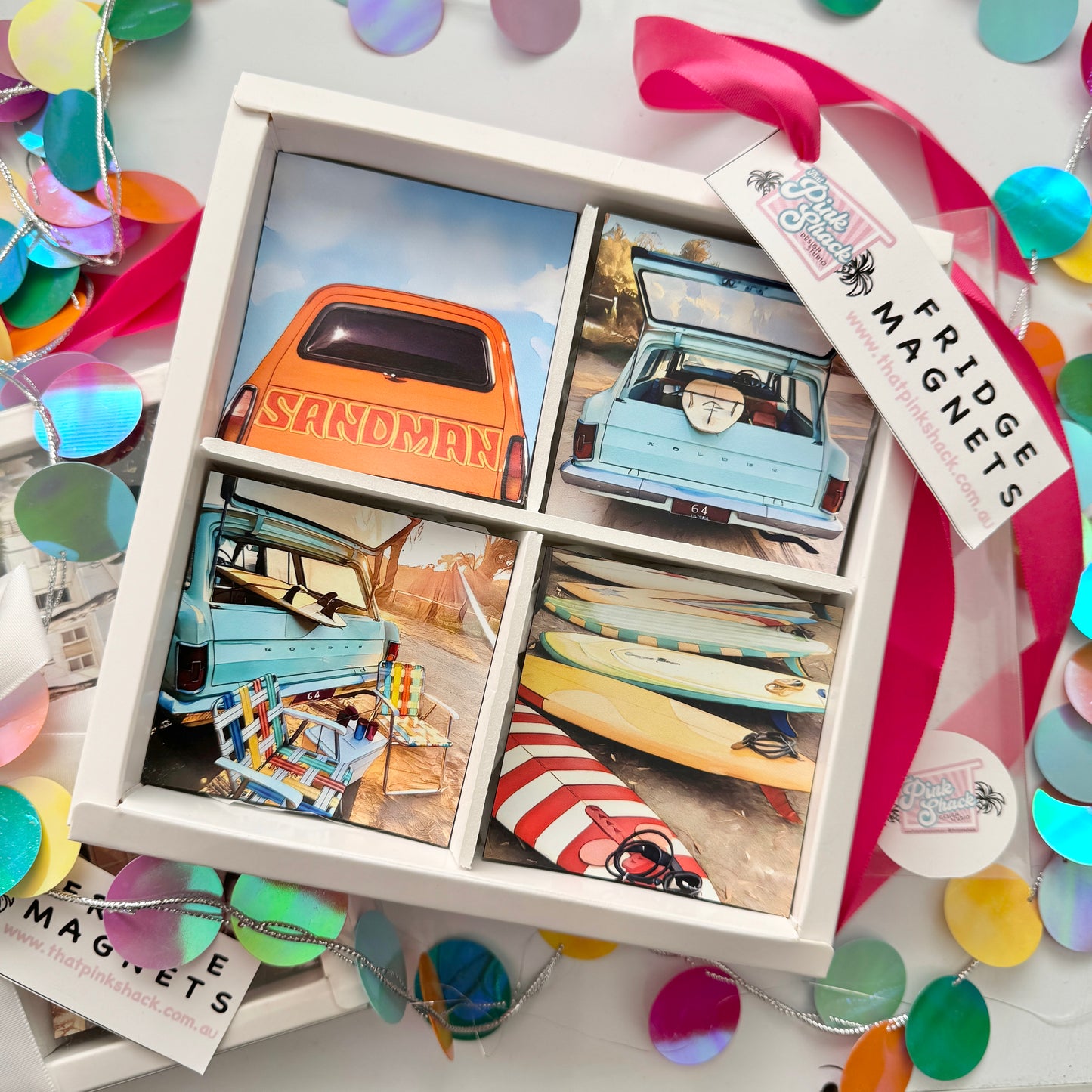 A gift box containing 4 retro fridge magnets designs featuring orange Holden sandman , classic eh Holden with chairs and esky , eh Holden with surfboard and vintage surfboards