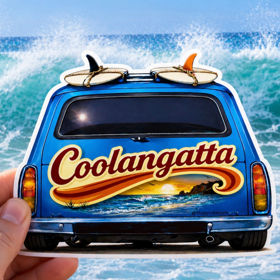 A die-cut sticker of a blue holden panel van with surfboards on top and the word 'Coolangatta' in large red lettering, held by a hand against a background of ocean waves.