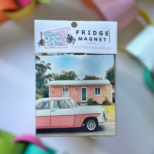 A pink Zeyher parked in front of a classic pink fibro beach shack fridge magnet in packaging