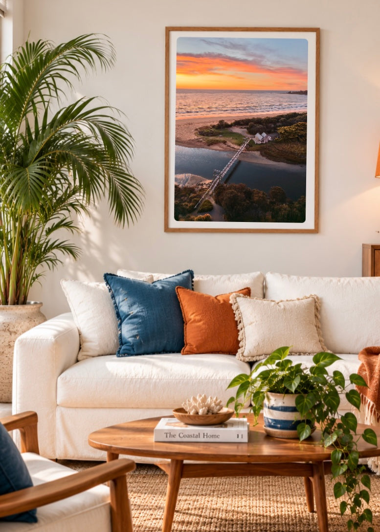 Colourful orange and yellow sunrise over the ocean from Erskine River in Lorne on Victoria’s Great Ocean Road framed in a print in a relaxed boho style loungeroom 