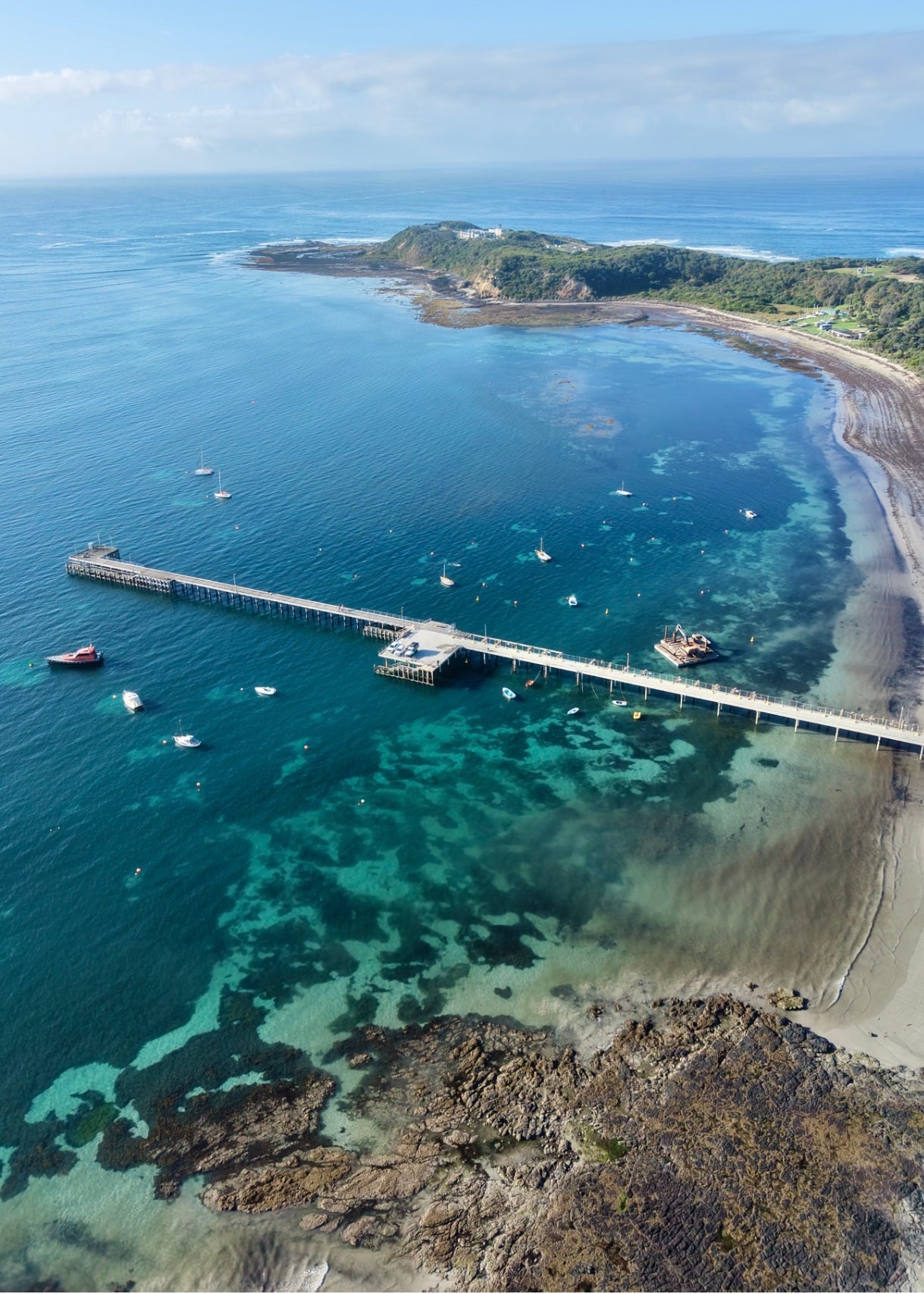 Aerial view of a the bay at Flinders with the pier, boats, and the point of the Gunnery