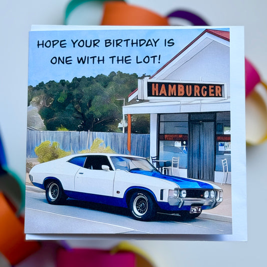 Greeting card of a classic car parked outside a hamburger shop saying hope your birthday is one with the lot