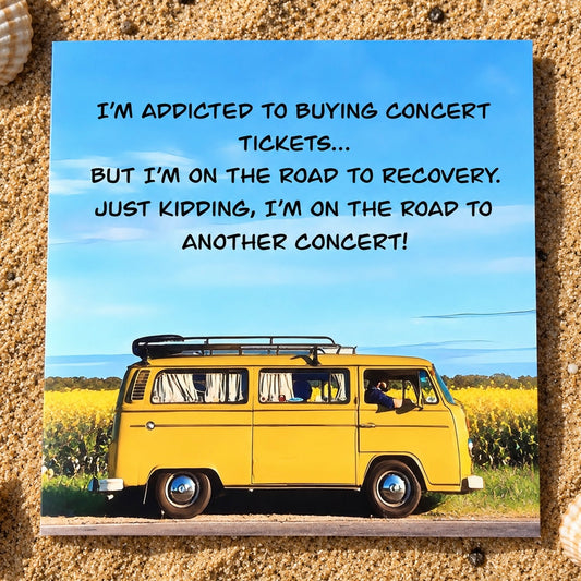 A square greeting card featuring a yellow vintage VW bus on a road with a blue sky background and the text 'I'M ADDICTED TO BUYING CONCERT TICKETS.