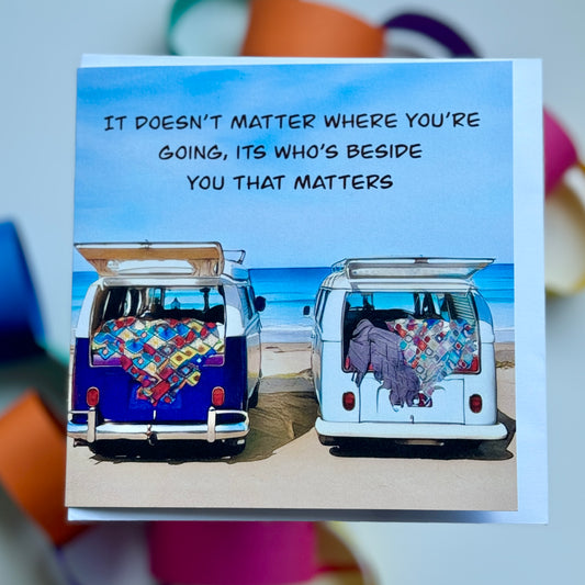 a greeting card with two kombis parked overlooking the beach with It doesn’t matter where you’re going, its who’s beside you that matters written on it 