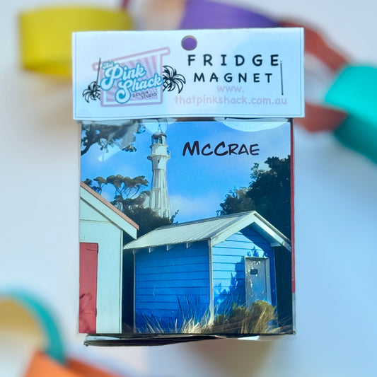 Fridge magnet in packaging with boatshed beach boxes and the lighthouse from the beach in McCrae victoria