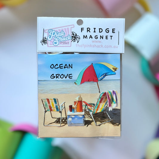 A fridge magnet with ocean grove beach on it and a vintage beach umbrella esky and chairs In packaging