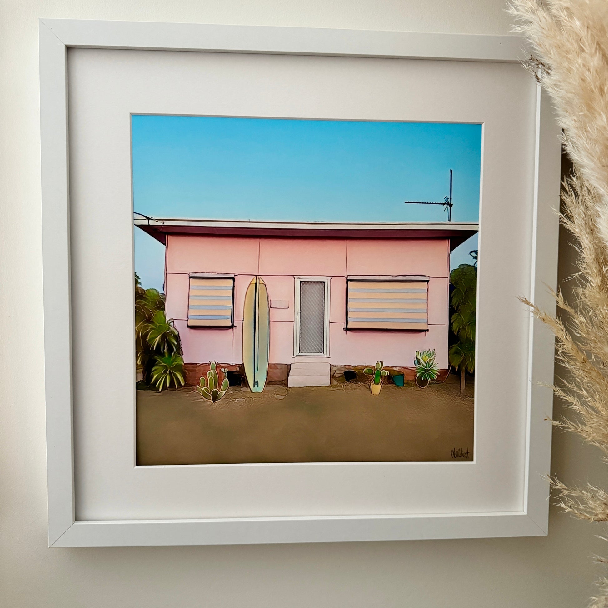 40cm x 40cm print of pink retro surf shack in a mat and white  frame