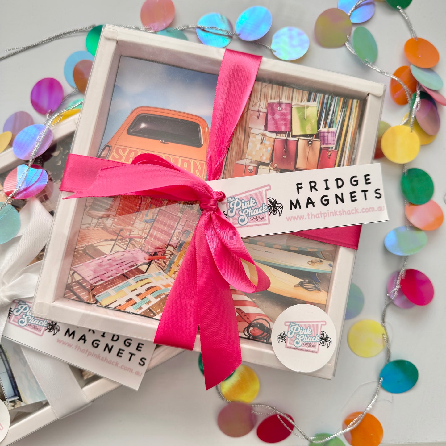 A gift box containing 4 retro fridge magnets designs featuring  orange Holden sandman , vintage eskies , vintage camp chairs and vintage surfboards With ribbon