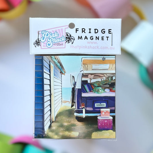 A fridge magnet of a kombi vw bus parked at the beach next to a boat shed beach box in packaging