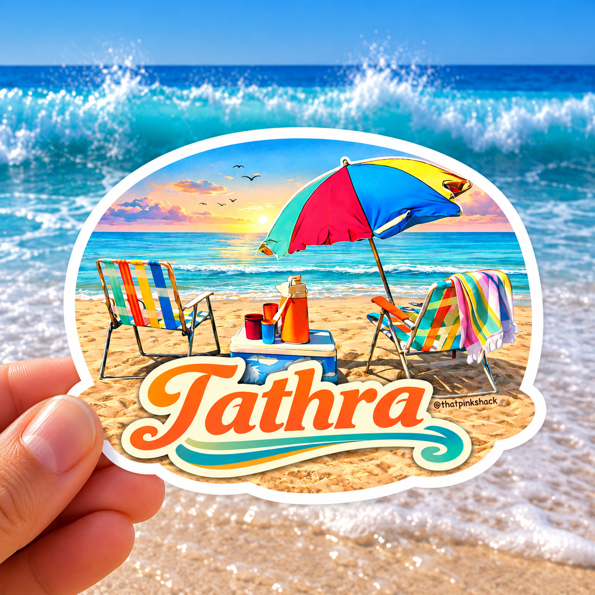 “Tathra retro beach sticker featuring colourful beach chairs, umbrella and cooler at sunset, photographed against an ocean and sandy beach background.”