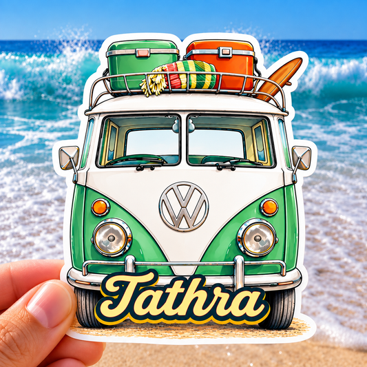 “Tathra retro Kombi van sticker with surfboard and colourful beach gear, photographed against a bright ocean and beach background.”