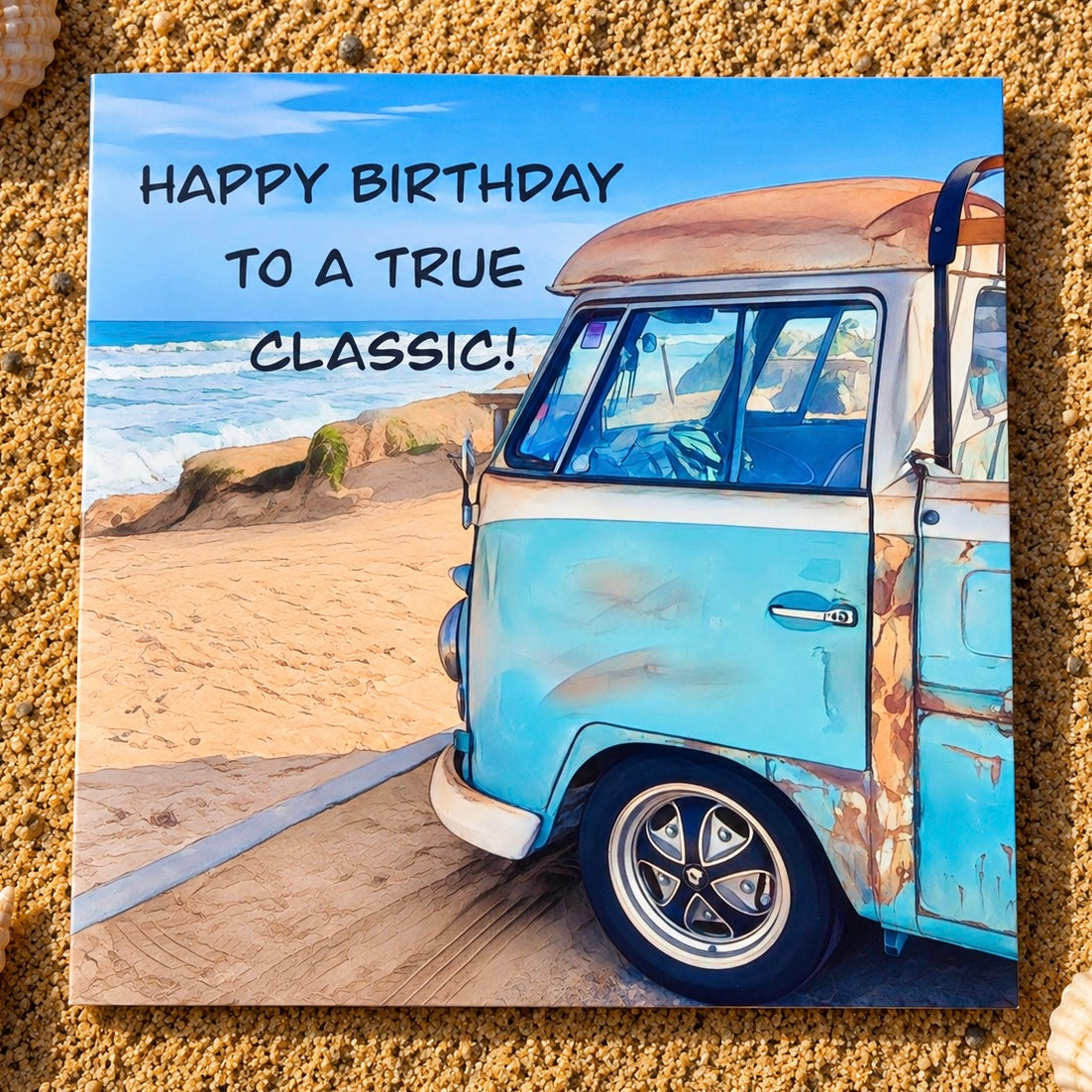A square greeting card featuring a beach scene with a light blue vintage van, sand, ocean, and the text 'HAPPY BIRTHDAY TO A TRUE CLASSIC!' displayed on the canvas, set against a sandy textured background.