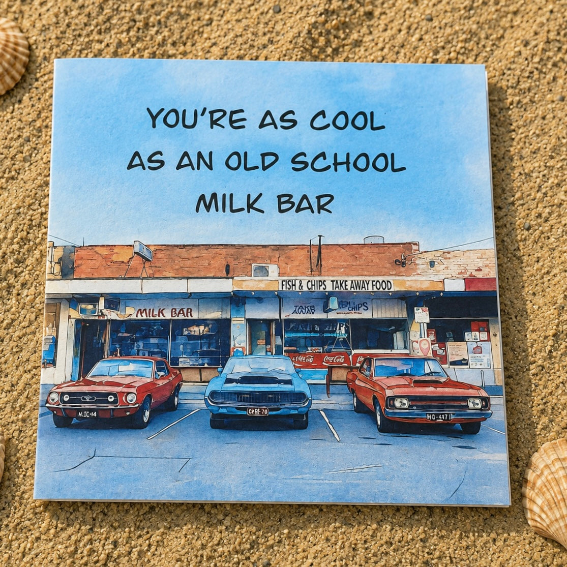 Classic cars parked outside a milk bar and fish and chip shop greeting card with envelope laying on the sand